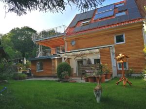 a house with solar panels on the roof at Ferienwohnung Hecht - Biketrail Fun & Relaxing in Wolfegg