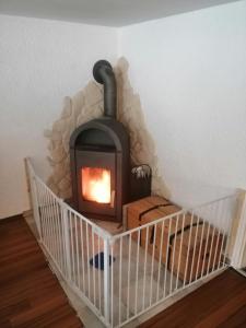 a stone wall with a fireplace in a room at Ferienwohnung Hecht - Relax or work in nature in Wolfegg