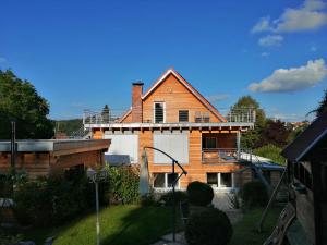 a house with a balcony on top of it at Ferienwohnung Hecht - Relax or work in nature in Wolfegg