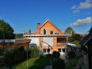 a house with a balcony on top of it at Ferienwohnung Hecht - Biketrail Fun & Relaxing in Wolfegg