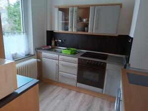 a kitchen with a sink and a stove top oven at Südkiez62 in Wilhelmshaven