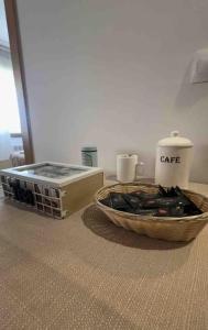 a table with a crate and a bowl of food at Apartamento Santiagos Road in O Pedrouzo