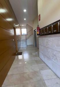 a hallway of a building with a fire extinguisher at Apartamento Santiagos Road in O Pedrouzo