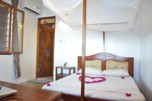 Postel nebo postele na pokoji v ubytování Lui Ushongo Beach House