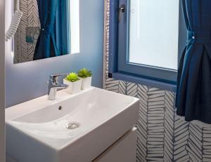 a bathroom with a white sink and a mirror at Club del Sole Rimini Family Resort in Rimini