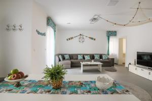 a living room with a couch and a table at 4seasons Apartments in Fonyód