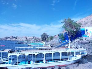 Łódź zakotwiczona jest w doku w wodzie w obiekcie Azoz Nubian House w mieście Aswan