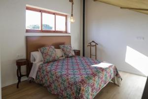 - une chambre avec un lit doté d'une couette et d'une fenêtre dans l'établissement El Campirri, à Daimés