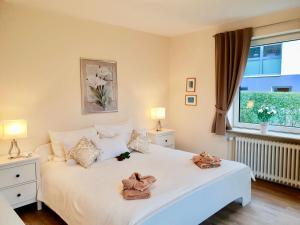 Un dormitorio con una cama blanca con ositos de peluche. en fewo1846 - Kranich - komfortable Wohnung mit 2 Schlafzimmern im Erdgeschoß, en Flensburg
