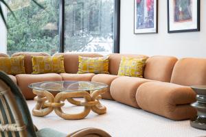 a living room with a couch and a glass table at Original Sokos Hotel Tapiola Garden Espoo in Espoo