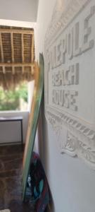 a pair of scissors in a container next to a wall at Pole Pole Beach House in Watamu