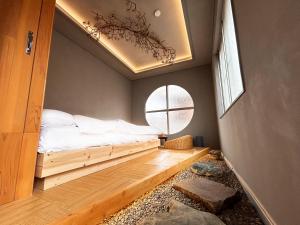 sypialnia z łóżkiem w pokoju z oknem w obiekcie 満竹華庵 manchikan w Tokio