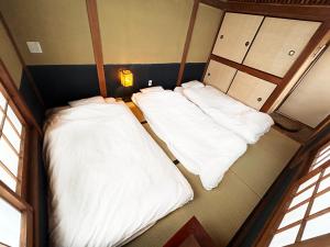 Postel nebo postele na pokoji v ubytování 満竹華庵 manchikan + 22 fotografií