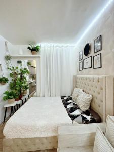 a bedroom with a large bed and a couch at Appartement proche stade de France et métro 12 in Saint-Denis