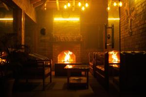 a living room with a fireplace and a couch at Kasar Himalaya Holiday Home, Binsar Rd in Almora
