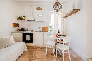 a kitchen and a living room with a table and chairs at Terrazza Maté in Molfetta +28 photos