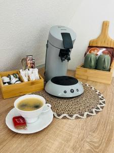 a coffee maker and a cup of coffee on a table at Mia’sFerienwohnung/Monteurwohnung in Herborn