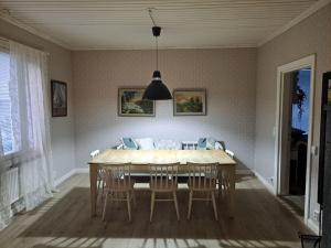 a dining room with a table and chairs at Spacious apartment in the city center in Vaasa