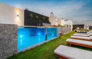 a backyard with a swimming pool and a house at Cozy 2BR Loft in the Heart of Miraflores in Lima