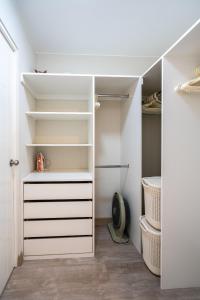 a walk in closet with white drawers and shelves at Modern 1BR Loft close to the seawalk of Miraflores in Lima