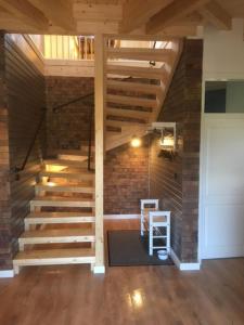 a staircase in a room with a brick wall at Ferienhaus Mühle "Neue Hoffnung" in Beidenfleth