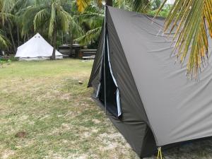 a tent is set up in a field with two tents at Salt Bay Kite Resort in Kalpitiya