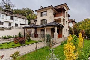 a large house with a garden in front of it at Casa MT - Boutique Villa in Gabrovo