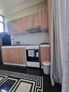 a kitchen with wooden cabinets and a stove top oven at The Residence Hotel in Addis Ababa +28 photos