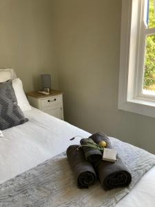 a bedroom with a bed with towels on it at Modern city townhouse with rooftop terrace in Cape Town