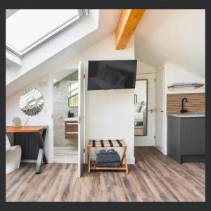 a living room with a table and a desk at Uno St Ives - Luxury Serviced Accommodation in St Ives
