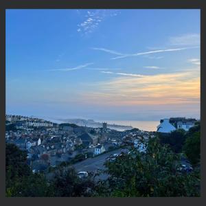 a view of a town at sunset with a city at Uno St Ives - Luxury Serviced Accommodation in St Ives