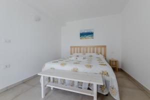a bedroom with a bed with a wooden headboard at Villa Torre Guaceto by Typney in Carovigno