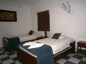 Postel nebo postele na pokoji v ubytování Hotel Shalom PHE Guaduas
