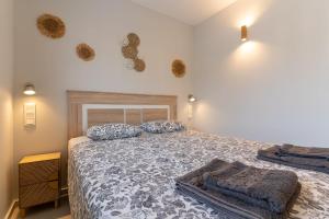 a bedroom with a bed and two pillows on it at rentafive - Gran casa reformada - Terraza in Santa Pola