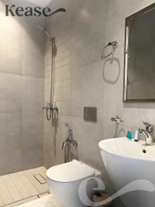 a bathroom with a shower and a toilet and a sink at Kease Hittin N-12 Lusso Hejaz Balcony GZ83 in Riyadh