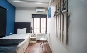 Ένα ή περισσότερα κρεβάτια σε δωμάτιο στο Elysium Gallery Hotel