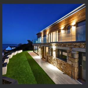 an exterior view of a building with a green lawn at Uno St Ives - Luxury Serviced Accommodation in St Ives