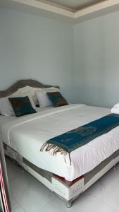 a large bed with white sheets and pillows on it at P&L21Resort in Khanom +9 photos