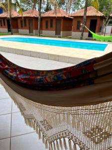 a reflection of a boat on the side of a pool at Pousada Nativo's in Nova Almeida