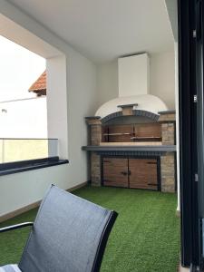 a kitchen with a stove and a chair in a room at Olimpiko in Vrdnik