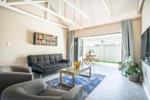 a living room with a couch and a table at El Dorado Hotel and Self Catering in Oudtshoorn