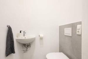 a bathroom with a toilet and a sink at Oktoberfest Oasis for up to 12 in Munich