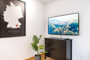 a flat screen tv sitting on top of a dresser at MARIENPLATZ Apartment 2 bedrooms living room kitchen in Munich