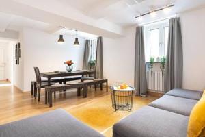 a living room with a table and a dining room at MARIENPLATZ Apartment 2 bedrooms living room kitchen in Munich
