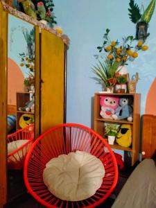a room with two red chairs and a shelf at WINDY HILL VŨNG TÀU HOMESTAY in Vung Tau