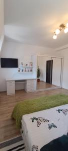 a living room with a bed and a mirror at Moonlight Apartments Sibiu in Sibiu