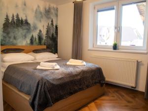 Posteľ alebo postele v izbe v ubytovaní Apartamenty Zakątek Harenda