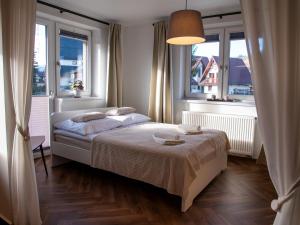 Posteľ alebo postele v izbe v ubytovaní Apartamenty Zakątek Harenda