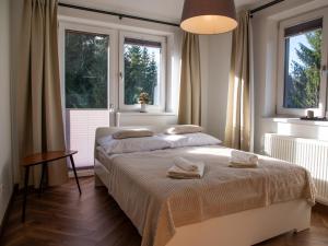 Posteľ alebo postele v izbe v ubytovaní Apartamenty Zakątek Harenda + 32 fotografií