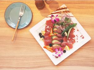 a plate of food sitting on top of a table at The BREAKFAST HOTEL MARCHE Ishigaki Island in Ishigaki Island